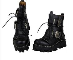 a pair of black boots with skulls on them