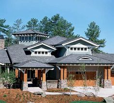 a large house with lots of windows on the front and side of it's roof