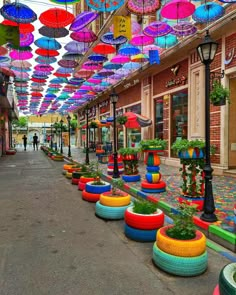 many colorful umbrellas are hanging from the ceiling