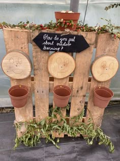 a wooden fence with potted plants on it and a sign that says how do you get about outside?