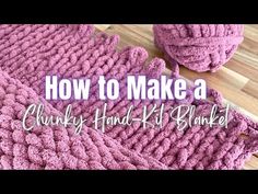 a pink crocheted blanket sitting on top of a wooden floor next to a pair of shoes