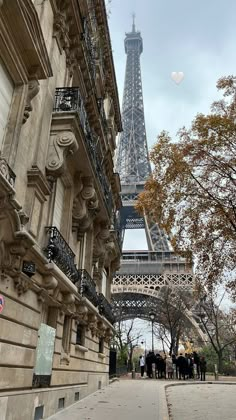 the eiffel tower in paris, france is seen from an alleyway between two buildings