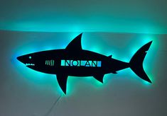 Personalized Great White Shark with or without lights This kids Great White Shark is personalized with your littles name. It can either used as a bedroom door hanger, nightlight or wall art for any room. You can choose with or without lights. Lights are fairy lights and will already be attached for easy set up. These lights are dual with battery operated and well as USB hook up to be able to be mounted anywhere even if you don't have an outlet nearby. Each sign will be ready for hanging 1/2 thic Shark And Dinosaur Bedroom, Kids Shark Bedroom, Toddler Shark Room, Shark Themed Bedroom Boy Rooms, Boys Shark Room, Baby Shark Bedroom, Boys Shark Bedroom, Boys Ocean Bedroom, Ocean Themed Bedroom For Boys