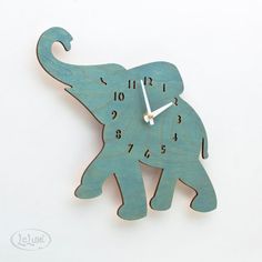 a wooden clock with an elephant on it's face and the words baby turquise / teal elephant