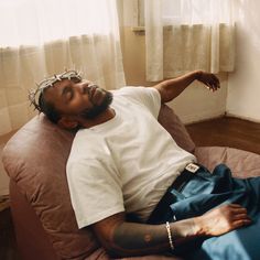 a man laying on top of a bean bag chair