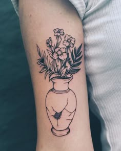 a black and white photo of a vase with flowers in it on the left arm