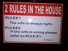 a red and white sign that says rules in the house