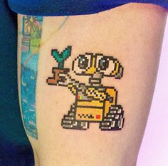 an image of a pixel art tattoo on the thigh