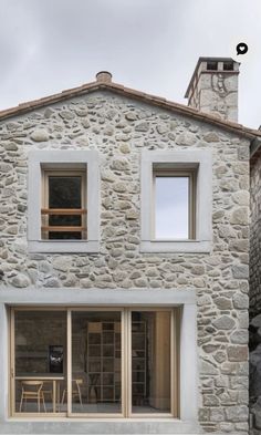 an old stone house with windows and doors