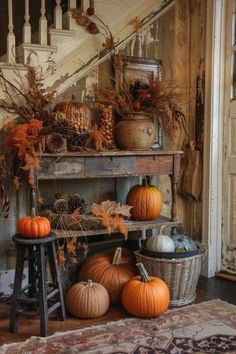 pumpkins and gourds are arranged on an old table