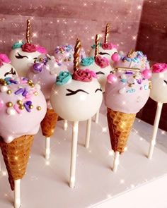 there are many ice cream cones with unicorn faces on them