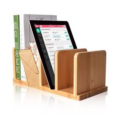 an ipad and tablet in a wooden holder