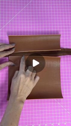 a person is making a brown paper roll