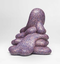 a purple sculpture sitting on top of a white table