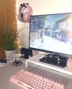 a desktop computer sitting on top of a white desk next to a keyboard and mouse