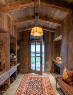 a room with wood paneling and a large rug on the floor next to a door