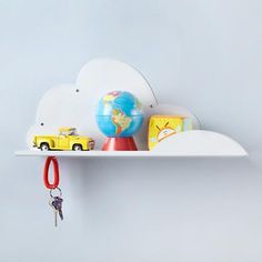 there is a shelf with toys on it and a keychain hanging from the top