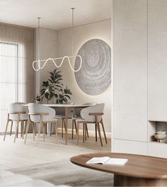 a dining room with white chairs and a round table