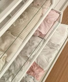 an open drawer with clothes in it