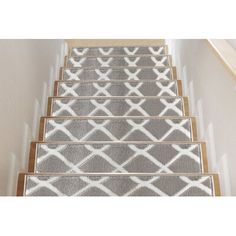 a set of carpeted stairs leading up to the top of a stair case in a house