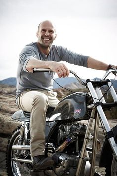 a man sitting on top of a motorcycle