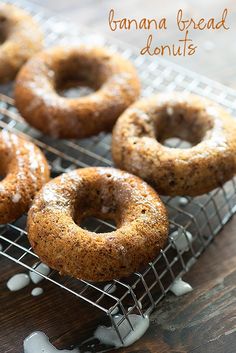 four baked donuts cooling on a wire rack