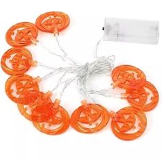 an orange string with halloween pumpkins on it and some wires attached to the strings