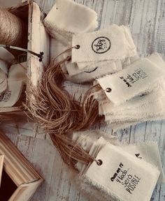 several pieces of cloth and twine on a white wooden table with an open box