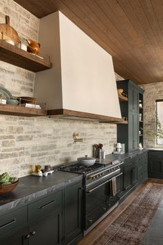 a kitchen with green cabinets and an oven