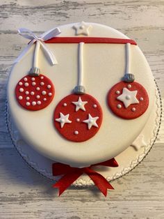 a white cake with red decorations on it