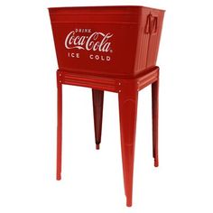 a red cooler sitting on top of a metal table