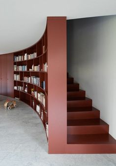 a child's toy is sitting on the floor in front of a bookshelf