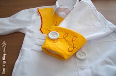 a yellow and white shirt with buttons on it