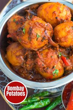 spicy vegan bombay potatoes in a bowl with the words spicy vegan bommay potatoes