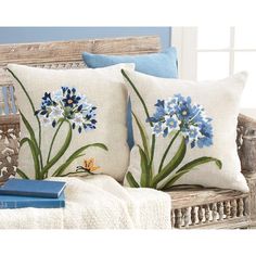 two pillows with blue flowers on them