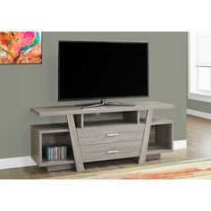 a flat screen tv sitting on top of a wooden entertainment center