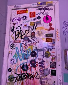 the door is covered in graffiti and stickers