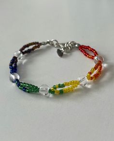 a multicolored beaded bracelet on a white surface