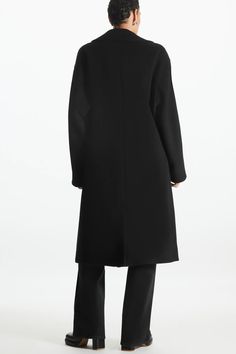 OVERSIZED DOUBLE-BREASTED WOOL COAT - BLACK - COS Black Wool Blazer With Concealed Fastening, Black Wool Coat With Concealed Placket And Lapel Collar, Black Wool Coat With Lapel Collar, Black Wool Coat With Double-breasted Button And Notch Lapel, Modern Black Wool Coat With Concealed Placket, Black Long Sleeve Wool Coat With Concealed Fastening, Classic Black Wool Coat With Concealed Fastening, Black Double-breasted Wool Coat With Concealed Placket, Black Wool Coat With Concealed Placket For Winter