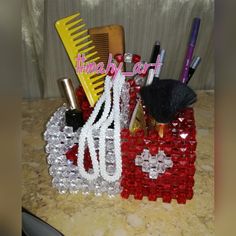 there are many different items on the counter top, including hairbrushes and combs