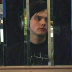 a young man is looking out the window