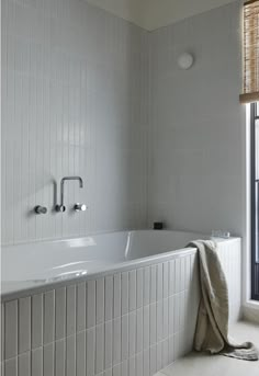 a white bath tub sitting next to a window