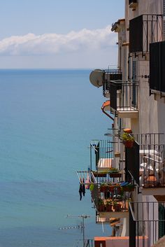 an apartment building overlooking the ocean with balconies