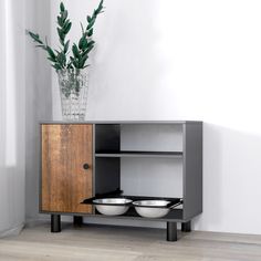 a wooden cabinet with two bowls on it