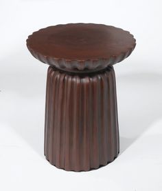 a small brown table sitting on top of a white floor