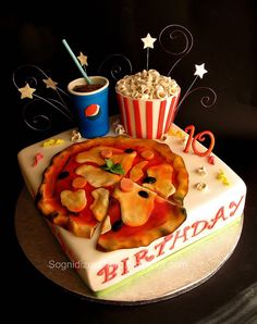 a birthday cake is decorated with popcorn and other items