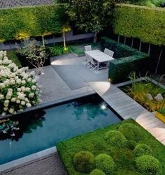 an aerial view of a garden and pool at night