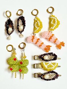 six pairs of beaded hair clips in various colors and sizes, with pearls on them