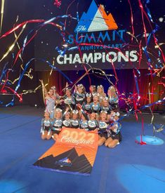 the cheerleaders pose for a group photo with confetti and streamers