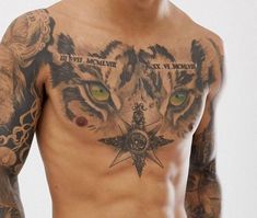 a man with tattoos on his chest has a tiger and compass tattoo on his chest